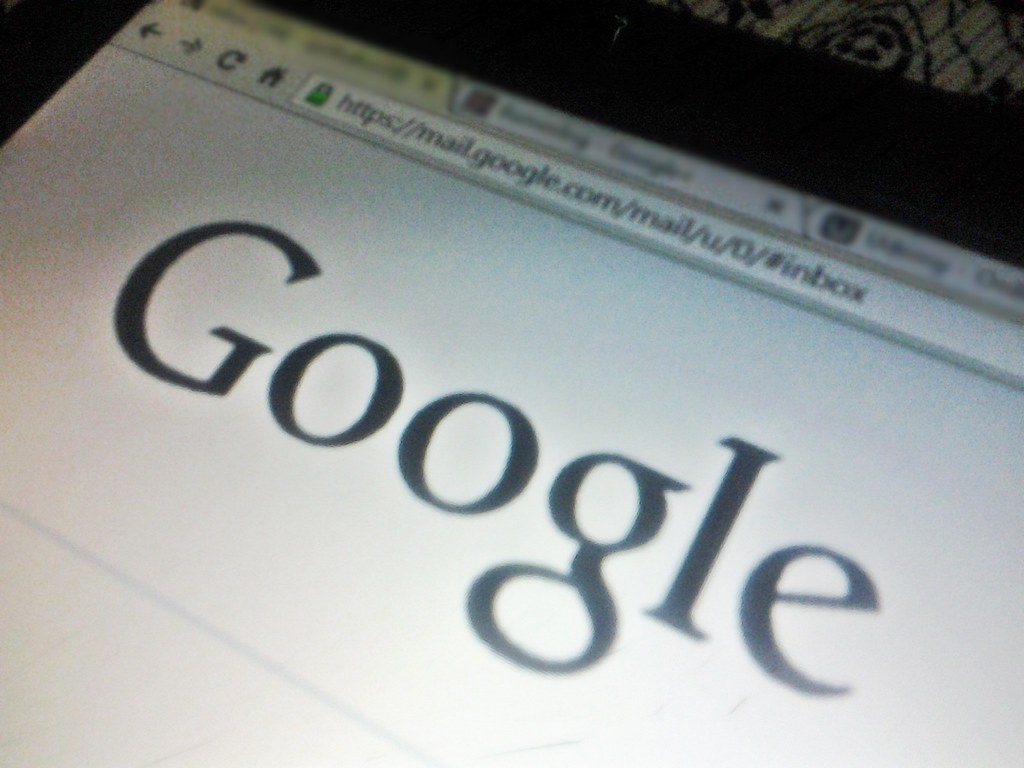 Close-up of the Google logo on a laptop browser screen, viewed at an angle