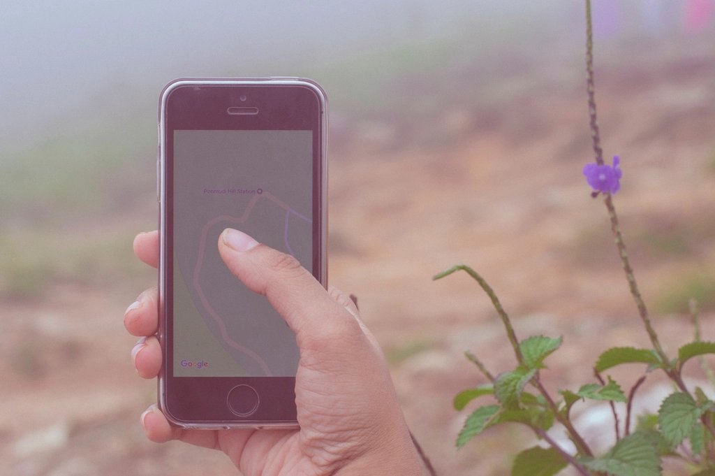 A smartphone displaying a map navigation app, held in a person's hand